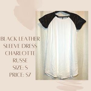 White dress with black leather sleeves.